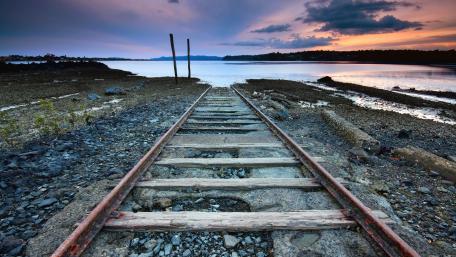 Abandoned Rails by the Tranquil Lake Sunset wallpaper
