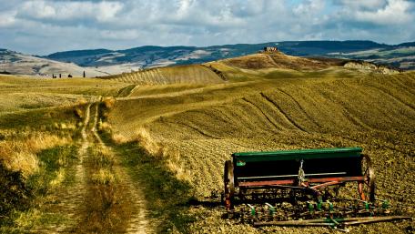 Scenic Vintage Landscape with Rolling Hills and Plowed Fields wallpaper
