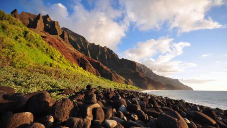 Serene Coastal Landscape with Majestic Mountains and Rocks wallpaper
