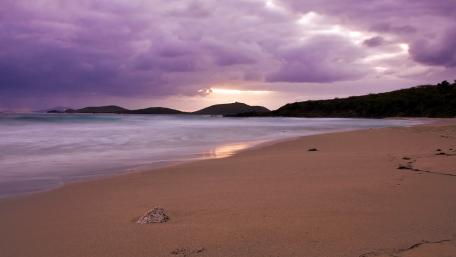 Dreamy Purple Sunset over Serene Beach wallpaper