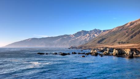 Serene Coastal Landscape with Majestic Mountains wallpaper