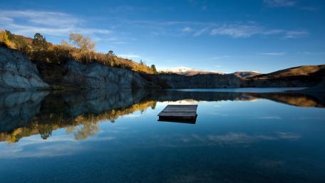 Serenity of a Calm Lake Reflecting Nature's Beauty wallpaper