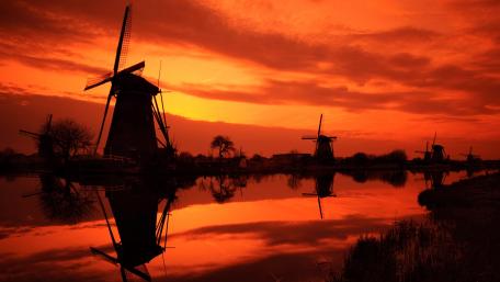 Fiery Sunset Over Windmills wallpaper