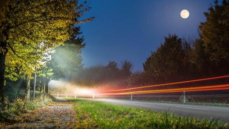 Moonlit Road with Light Trails wallpaper