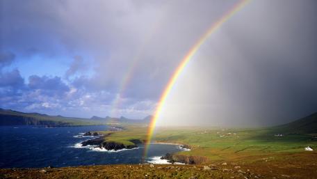 Vibrant Double Rainbow Over Coastal Landscape wallpaper