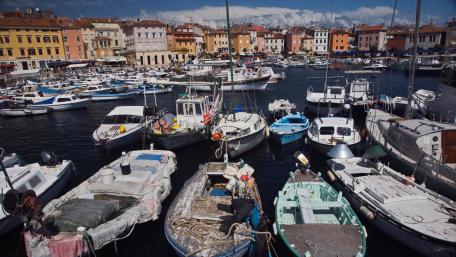 Charming Harbor Scene with Colorful Boats and Buildings wallpaper