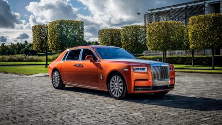 Luxurious Rolls-Royce in Stunning Orange Finish wallpaper