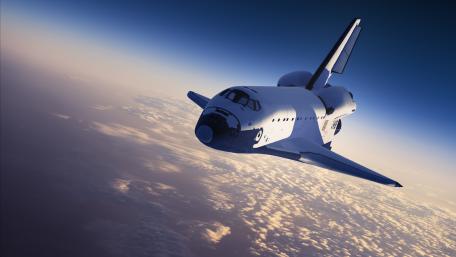 Space Shuttle Gliding Over Earth's Horizon wallpaper