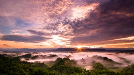 Breathtaking Sunrise Over Mystical Foggy Landscape wallpaper