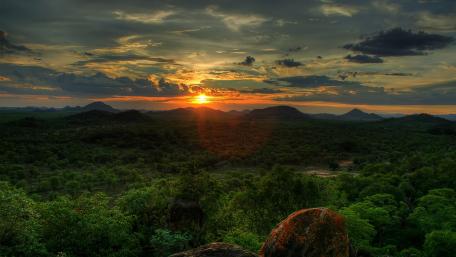 Majestic Sunset Over Lush Green Landscape wallpaper