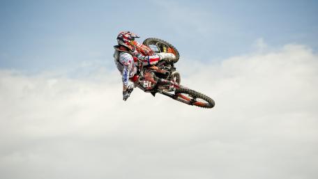 Thrilling Motorcycle Stunt in Mid-Air wallpaper