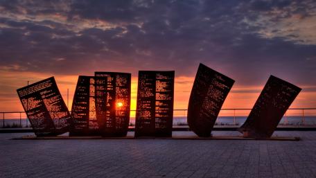 Breathtaking Sunset Behind Sculptural Art Installation wallpaper