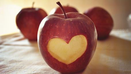 Apples with Heart Cutouts Create a Romantic Atmosphere wallpaper
