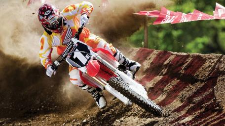 Thrilling Motocross Action on Dirt Track wallpaper