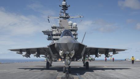 Futuristic Fighter Jet on Aircraft Carrier Deck wallpaper