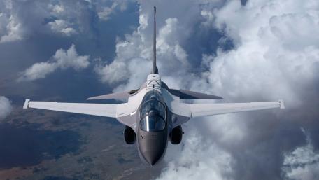 High-Flying Military Jet Over Dramatic Clouds wallpaper