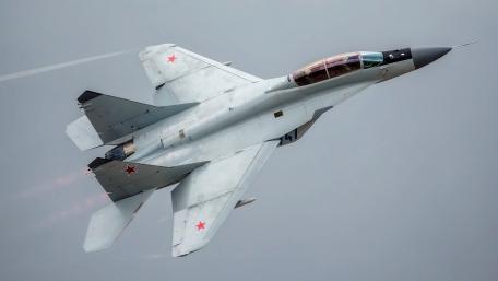 Sleek Fighter Jet in Action Overhead wallpaper