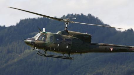 Military Helicopter in Action Above Mountains wallpaper