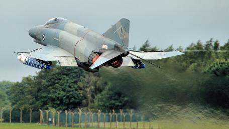 Jet Fighter in Action Above the Landscape wallpaper
