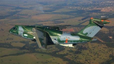Military Aircraft in Flight Over Scenic Landscape wallpaper