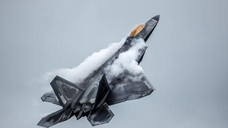 Fighter Jet in Action Above the Clouds wallpaper