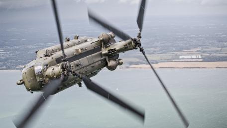 Military Helicopter in Action Above the Coastline wallpaper