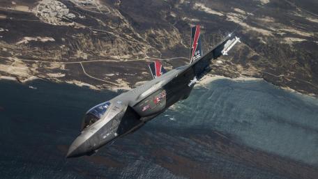 Fighter Jet in Flight Over Ocean View wallpaper