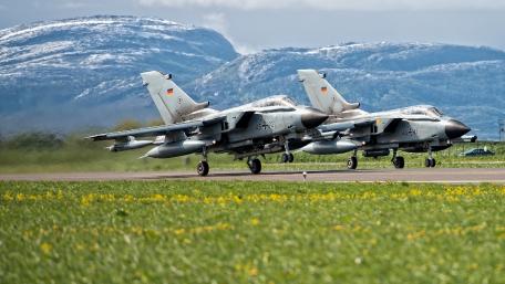 Fighter Jets in Action Over Scenic Landscapes wallpaper