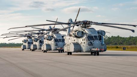 Powerful Military Helicopters on the Tarmac in Formation wallpaper