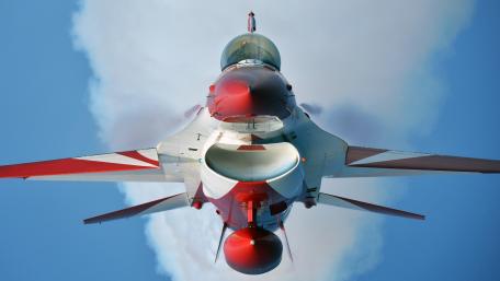 Fighter Jet in Action Above the Clouds wallpaper