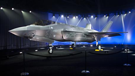 Sleek Fighter Jet Displayed in Stunning Lighting Showcase wallpaper