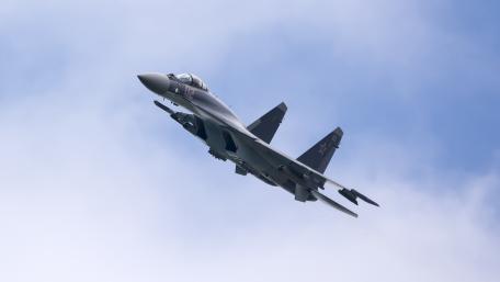 Sleek Fighter Jet in Action Above the Clouds wallpaper