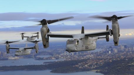 Military Aircraft in Formation Flight Over Cityscape wallpaper