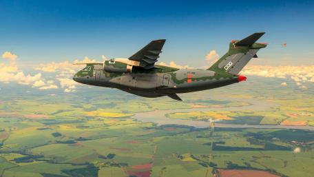 Military Aircraft in Flight Over Scenic Landscape wallpaper