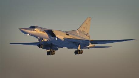 Sleek Bomber in Flight Over Sunset Scene wallpaper