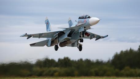 Military Jet in Action Above Scenic Landscape wallpaper