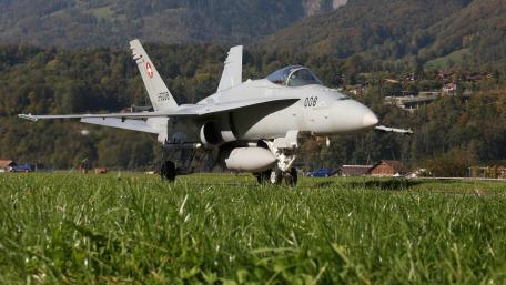 Fighter Jet on the Runway in a Scenic Landscape wallpaper