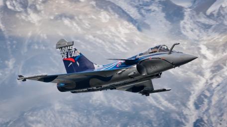 Fighter Jet in Action Over Mountains wallpaper