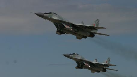 Fierce Skies with Fighter Jets in Formation wallpaper