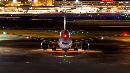 Airport at Night with Colorful Lights and Aircraft Details wallpaper