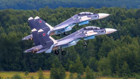 Sleek Fighter Jets in Action Above the Landscape wallpaper