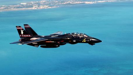 Fighter Jet Soaring Over Turquoise Waters wallpaper
