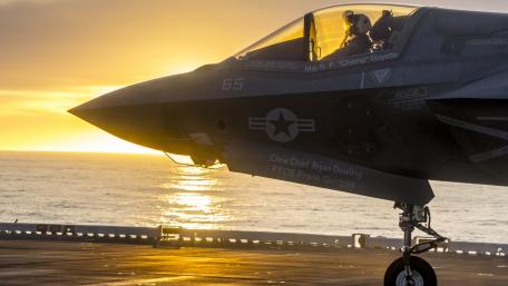 Fighter Jet Ready for Mission at Sunset wallpaper