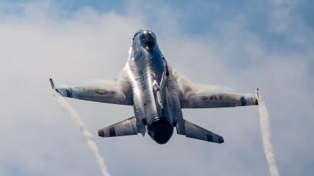 Fighter Jet in Action Above the Clouds wallpaper