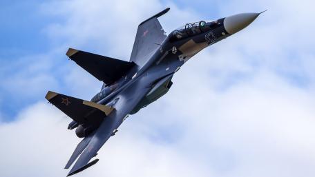 Sleek Fighter Jet in Action Above the Clouds wallpaper