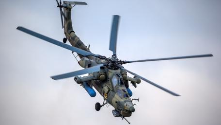 Military Helicopter in Action Above the Clouds wallpaper