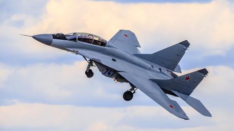 Majestic Fighter Jet Soars High Above Clouds wallpaper
