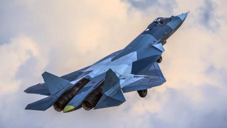 Futuristic Fighter Jet Ascending in the Sky wallpaper