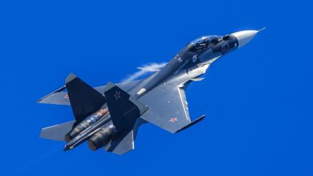 Sleek Jet Soaring Against a Bright Sky wallpaper