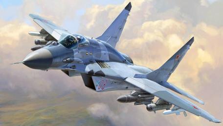 Sleek Fighter Jet Soaring Through the Clouds wallpaper